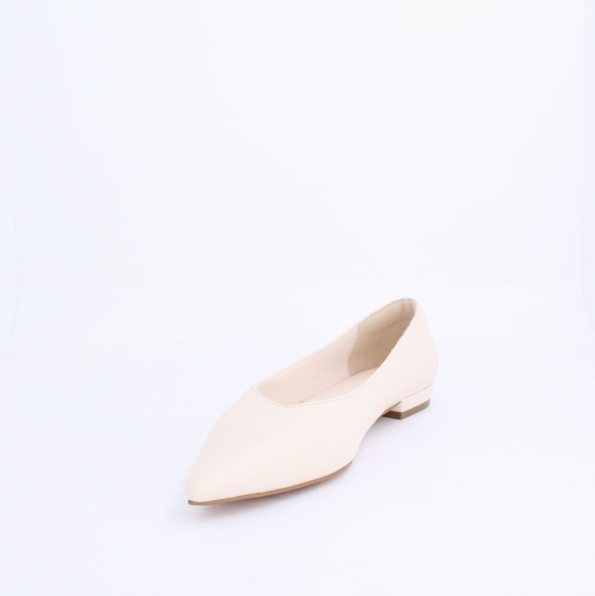 Cream Kiril flat pump style shoe with minimalist design, faux leather upper, and under 2cm heel, perfect for versatile outfits.