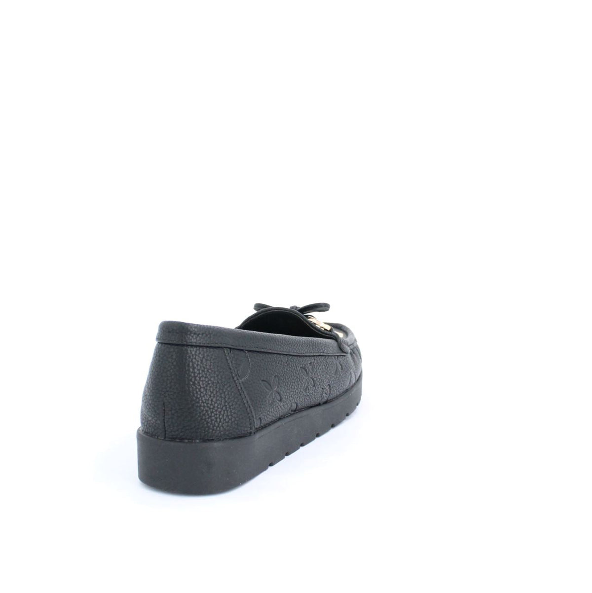 Black Adela moccasins with minimalist design and embossed details, featuring a flexible rubber sole with deep grooves for traction.