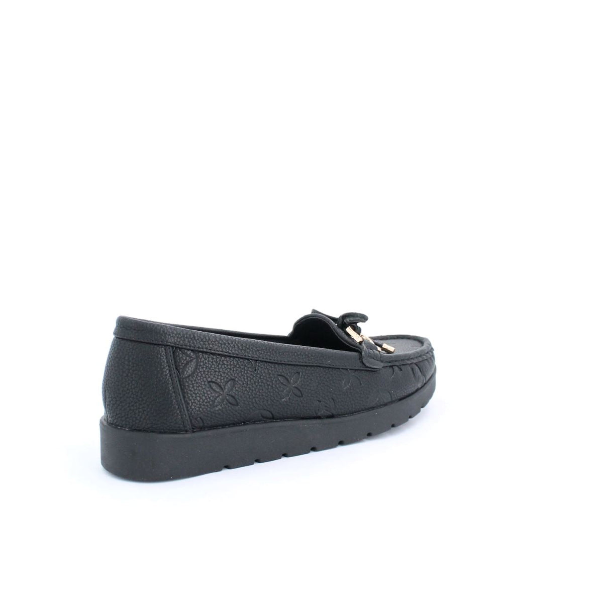 Black Adela moccasins with embossed detail, minimalist design, and flexible sole for versatile everyday wear.